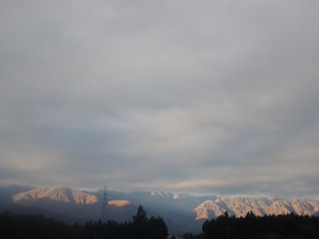 朝、南アルプスの裾野に霜が降りたようだ